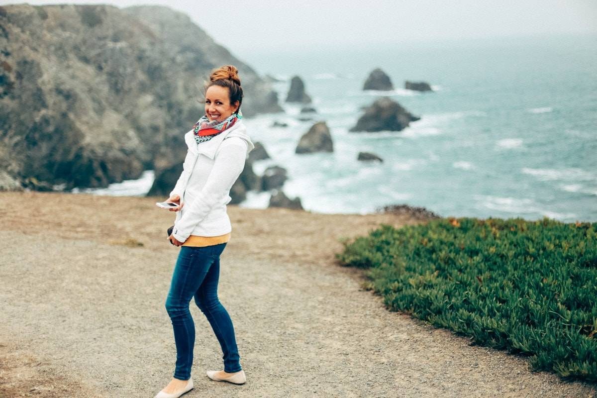 Woman smiling near the ocean.