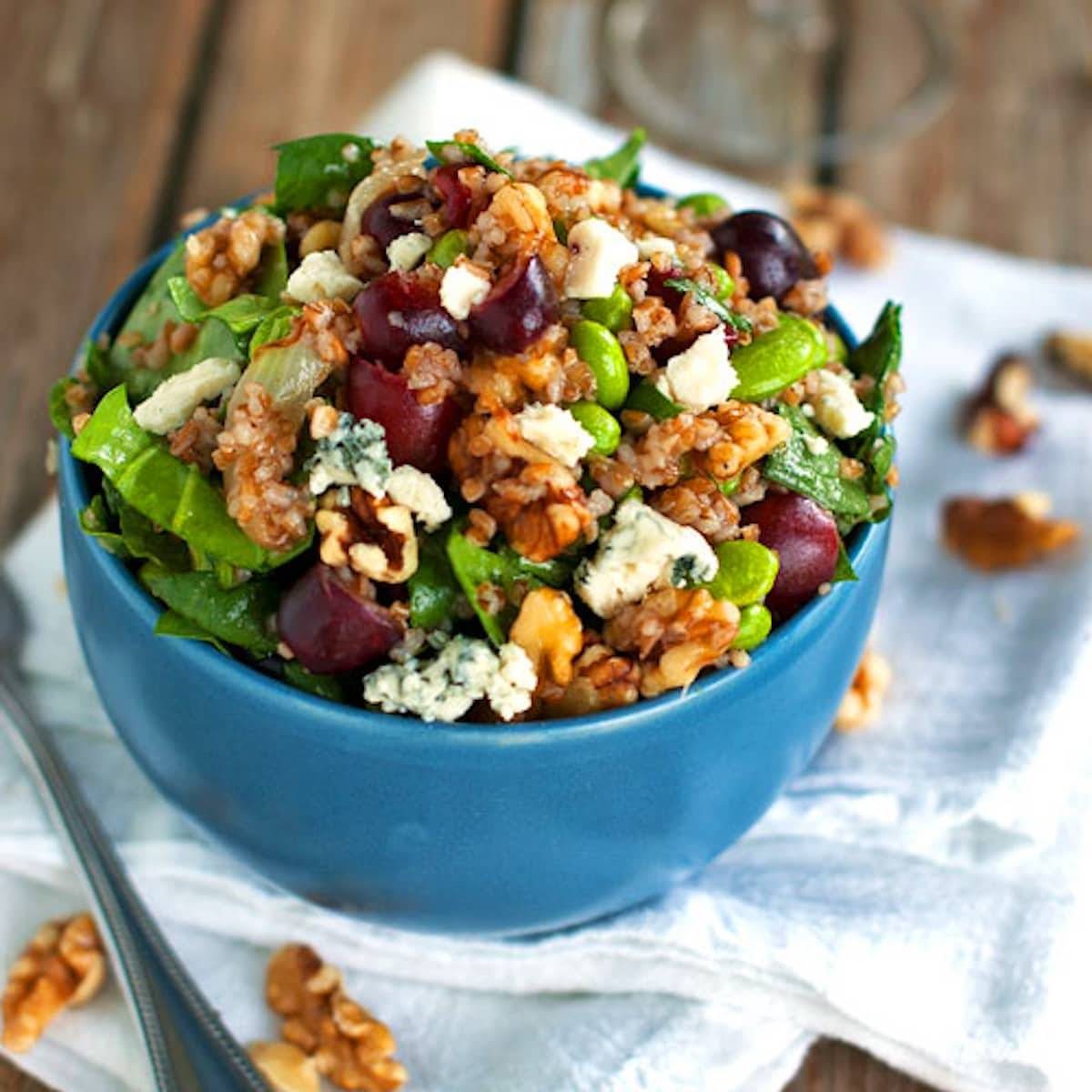 Honey walnut power salad in a blue bowl.