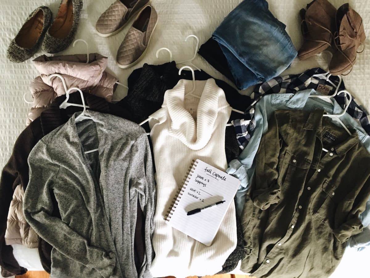 Clothing laying out on a bed.