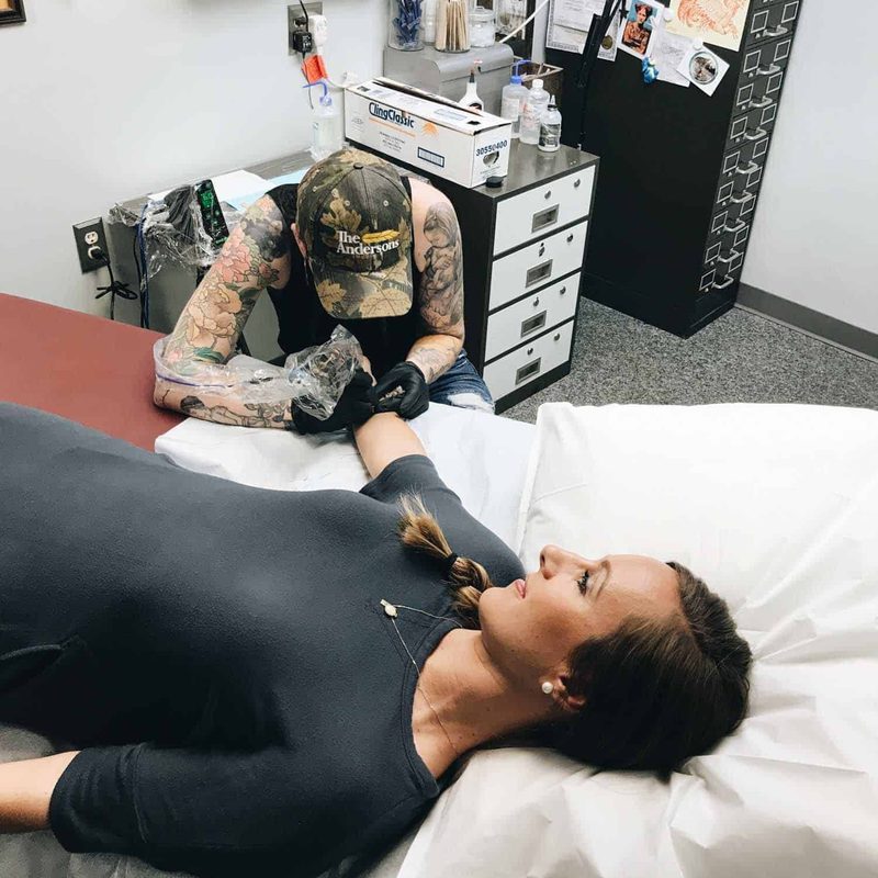 Lindsay getting a tattoo.